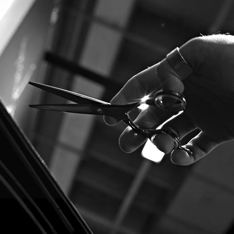 Scissors with ergonomic handles on a black and white image.