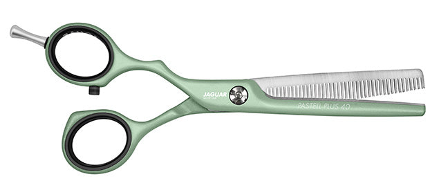 Green hairdressing scissors with teeth.