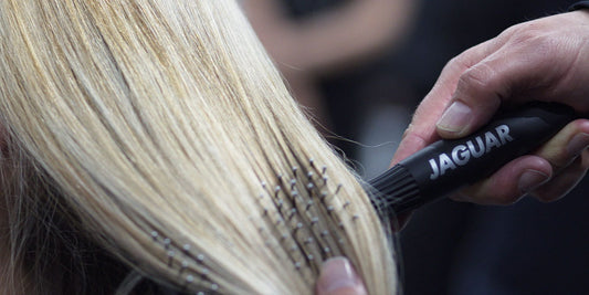 Black paddle brush with bristles.